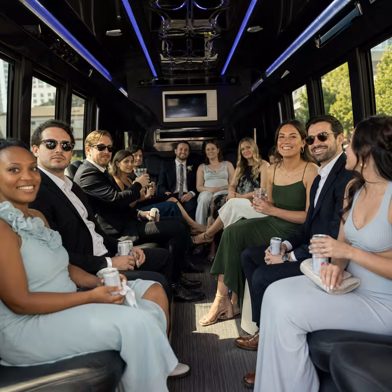 Wedding guests seated inside a New Orleans party bus