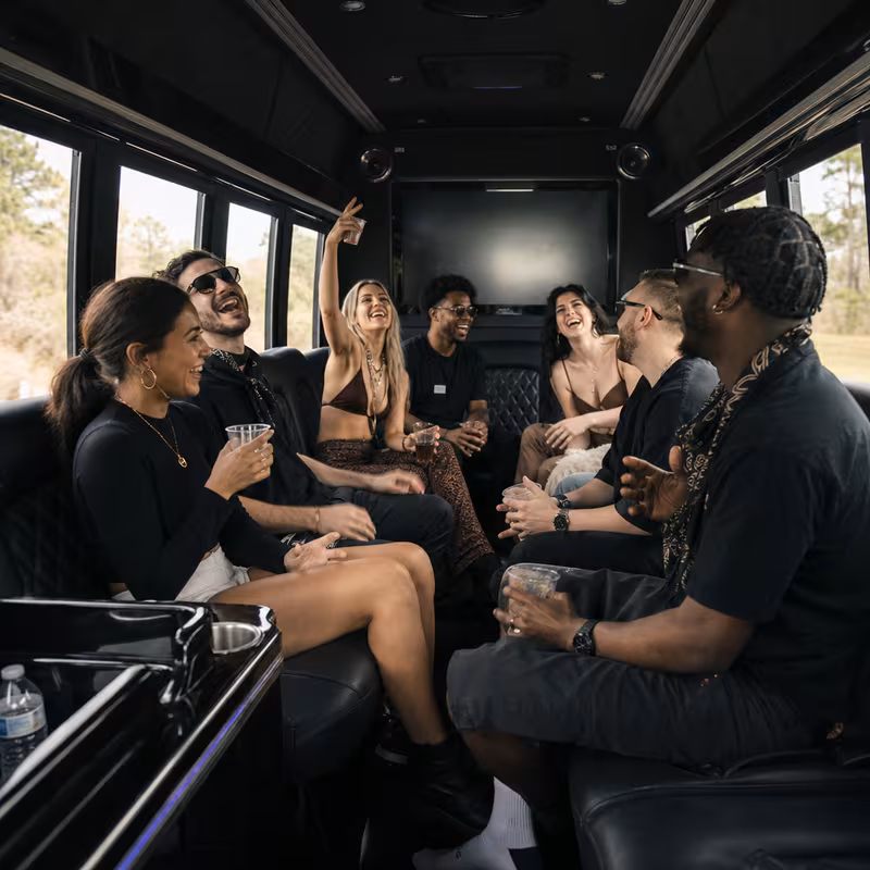 Group boarding a white charter bus for Concert Transportation transportation in New Orleans