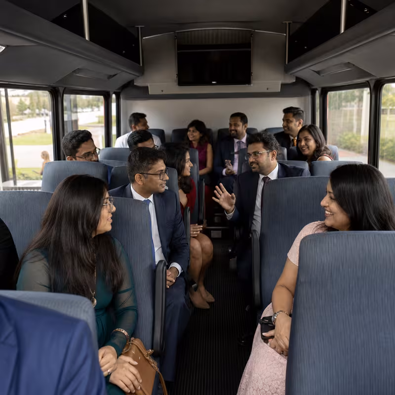 Group boarding a white charter bus for Private Event Transportation transportation in New Orleans