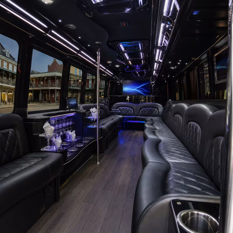 Party bus interior with wraparound leather seating and LED lighting in New Orleans